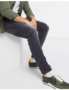 ASOS DESIGN - Jeans slim elasticizzati nero slavato con strappi sulle ginocchia e abrasioni
