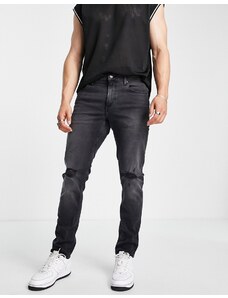 ASOS DESIGN - Jeans slim elasticizzati nero slavato con strappi sulle ginocchia