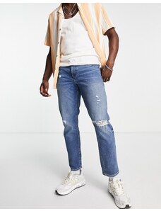 ASOS DESIGN - Jeans affusolati stretch lavaggio scuro con strappi sulle ginocchia-Blu