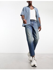ASOS DESIGN - Jeans stile skater lavaggio blu scuro con sfumature