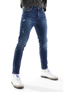 ASOS DESIGN - Jeans spray on power stretch blu lavaggio scuro con abrasioni