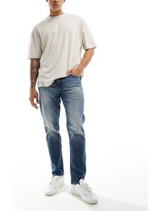 ASOS DESIGN - Jeans affusolati elasticizzati lavaggio blu medio vintage