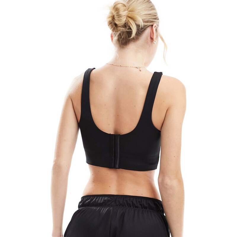 Nike Training Nike - Swoosh - Reggiseno sportivo a supporto leggero nero stile corsetto con logo