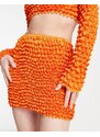 Annorlunda - Minigonna arancione vivace con texture stile popcorn in coordinato