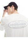 Timberland - T-shirt bianco sporco con stampa riflettente del logo sul retro